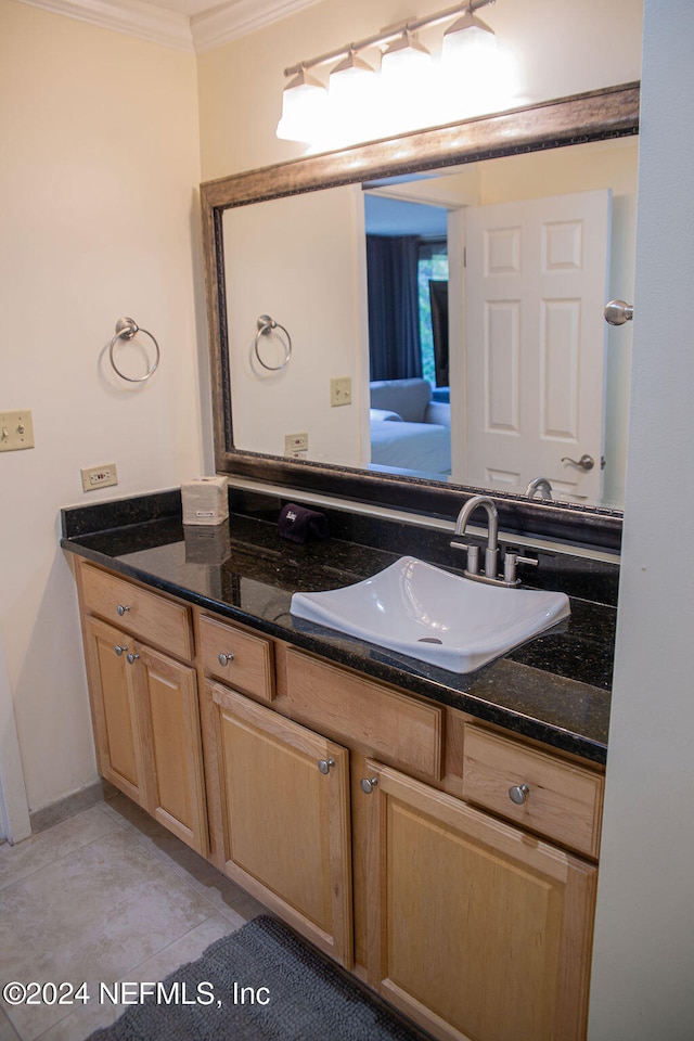 bathroom with tile patterned flooring, vanity, and crown molding