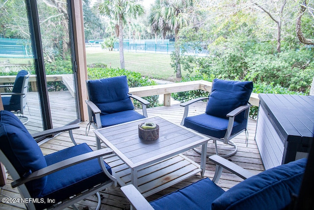 wooden terrace featuring a yard