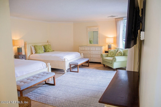 bedroom featuring hardwood / wood-style floors and ornamental molding