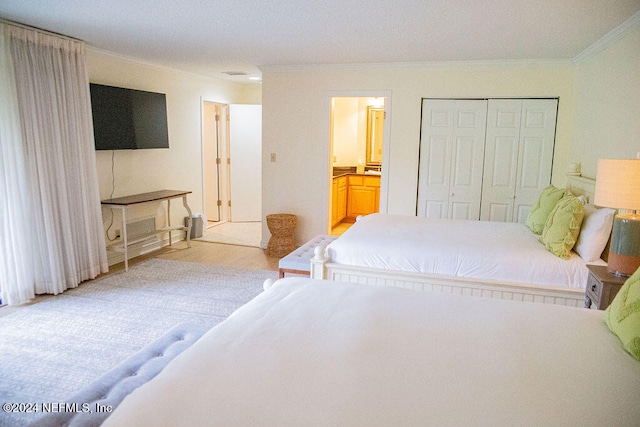 bedroom featuring a closet, crown molding, connected bathroom, and light hardwood / wood-style flooring