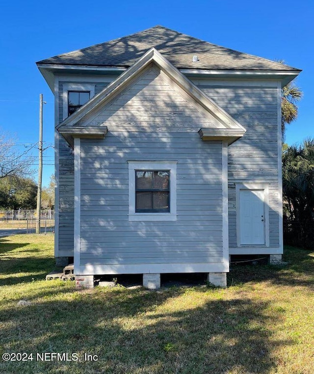 view of property exterior with a yard