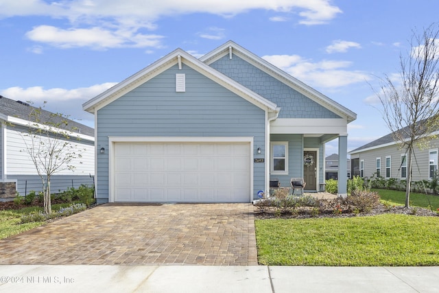 view of front of house featuring a front yard and a garage