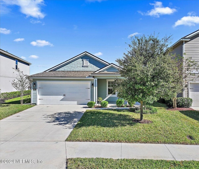 view of front facade with a garage and a front lawn