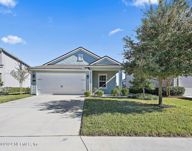 view of front of house featuring a front yard and a garage