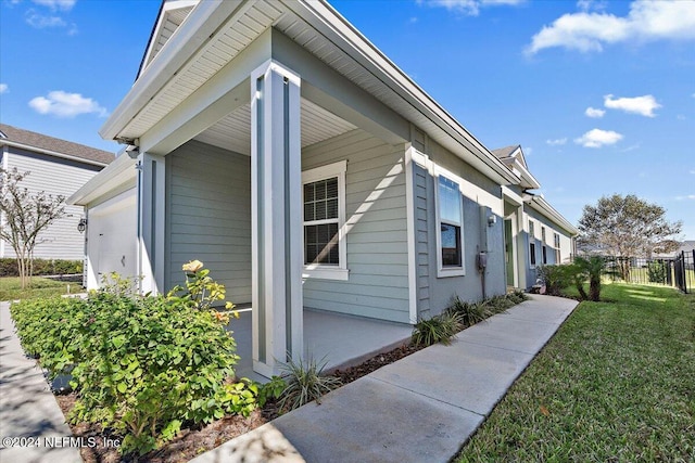 view of side of property featuring a yard