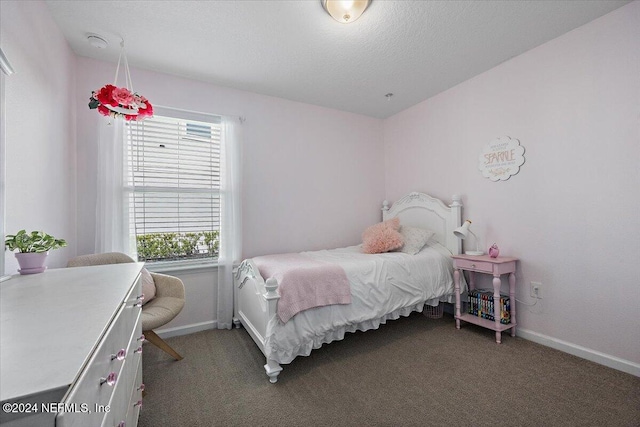 bedroom featuring carpet and a textured ceiling