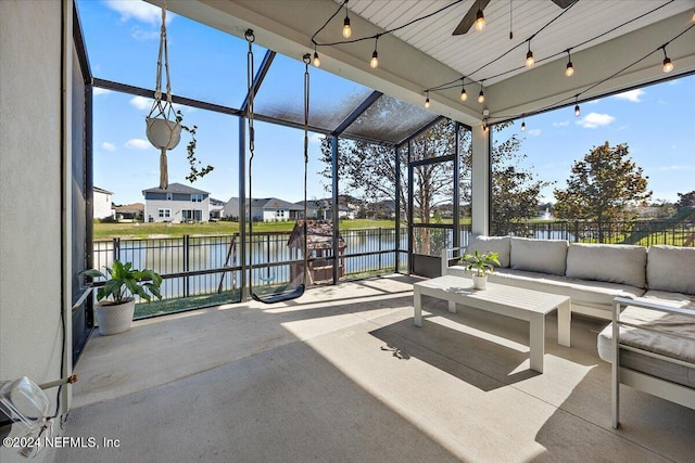 view of patio featuring outdoor lounge area, ceiling fan, and a water view