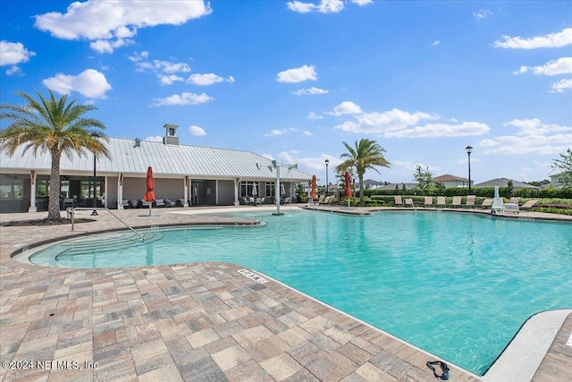 view of swimming pool featuring a patio area