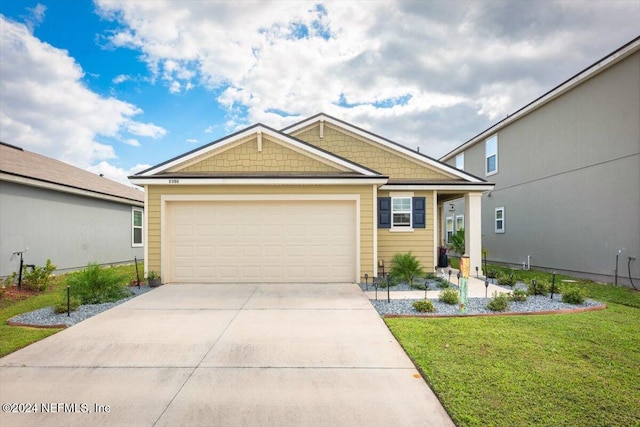 view of front of house featuring a garage and a front yard