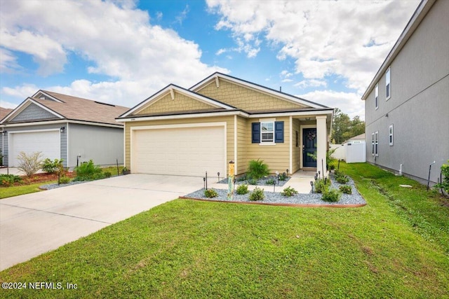 view of front of property featuring a front yard and a garage