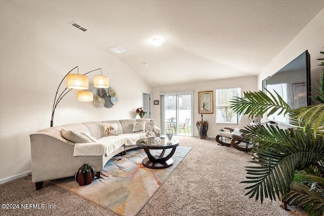 carpeted living room with a textured ceiling and vaulted ceiling