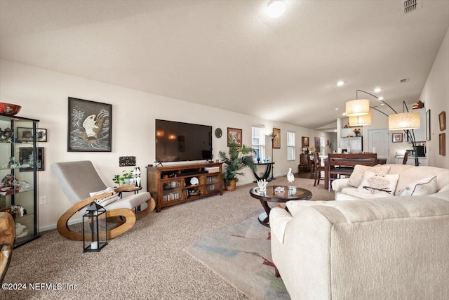 carpeted living room with vaulted ceiling