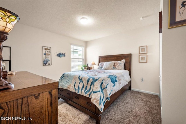 carpeted bedroom featuring a textured ceiling