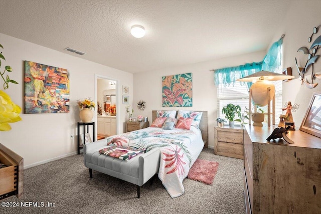 carpeted bedroom with connected bathroom and a textured ceiling