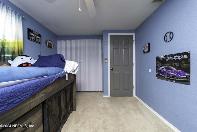 carpeted bedroom featuring ceiling fan