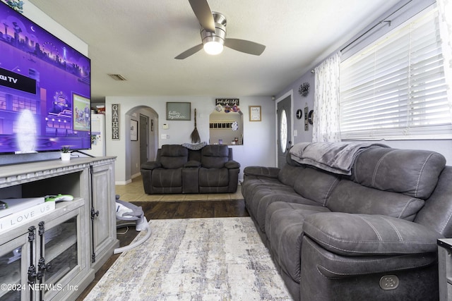 living room featuring ceiling fan and hardwood / wood-style flooring