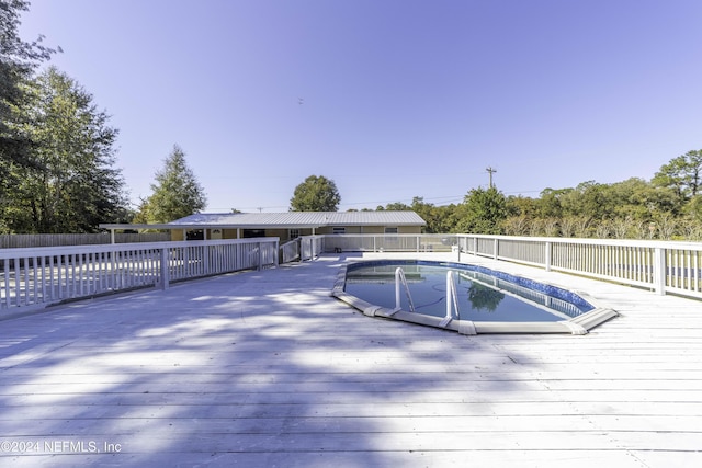 view of swimming pool featuring a deck