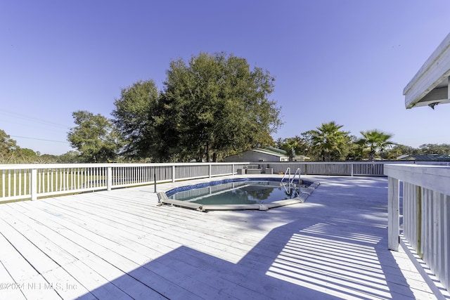 deck with a fenced in pool