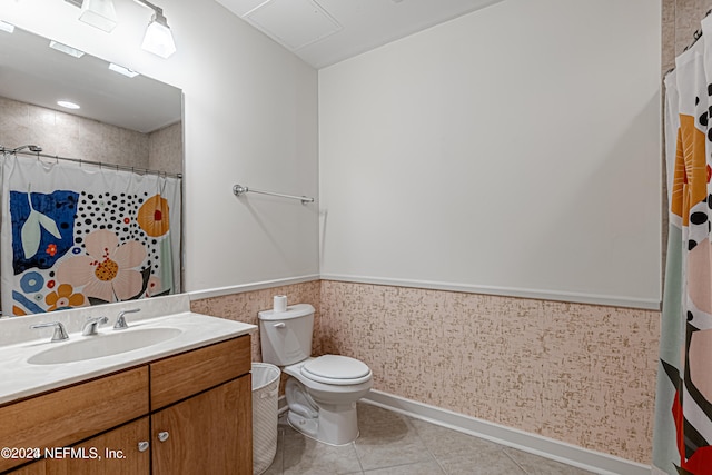 bathroom with tile patterned flooring, vanity, and toilet