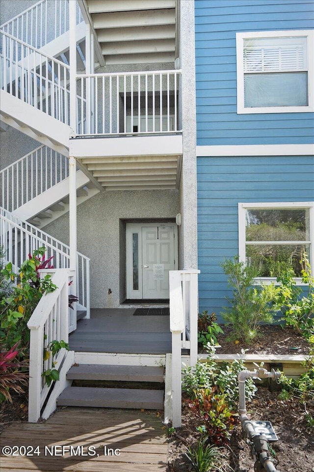 view of exterior entry with a balcony