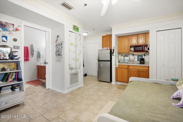 kitchen with stainless steel refrigerator, ceiling fan, and crown molding