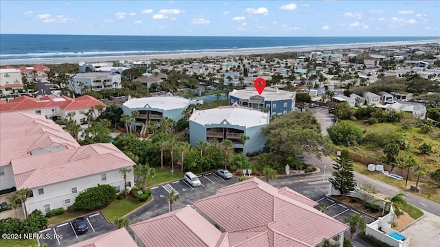 drone / aerial view featuring a water view and a view of the beach