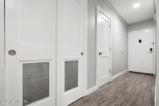 hallway with crown molding and wood-type flooring