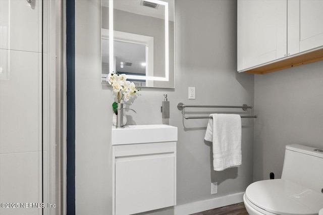 bathroom with vanity and toilet