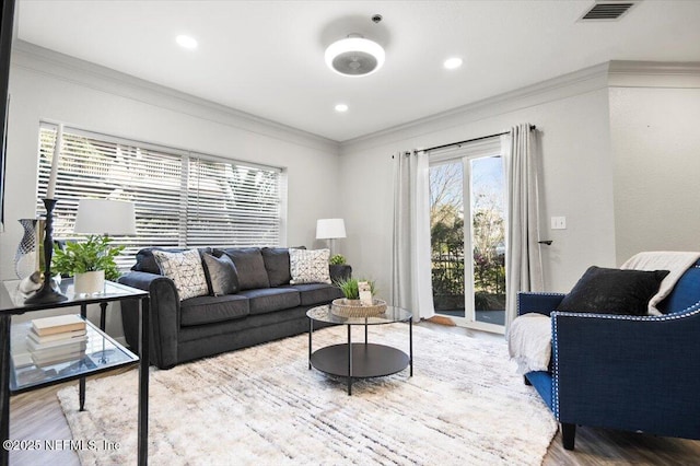 living room featuring crown molding and hardwood / wood-style floors