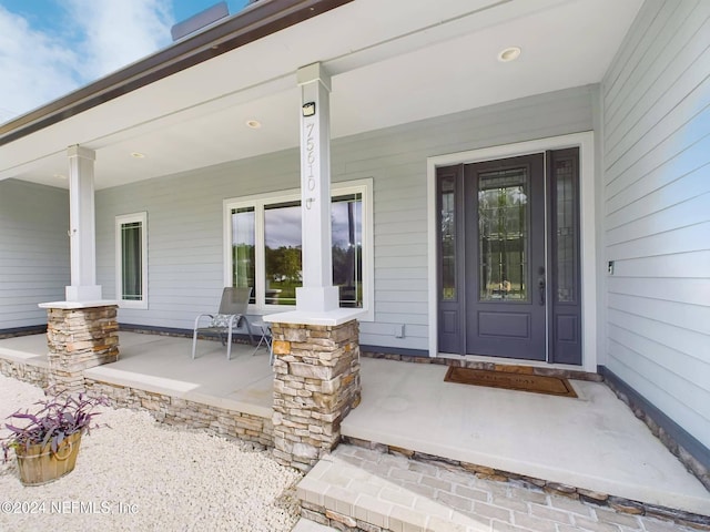 doorway to property with covered porch