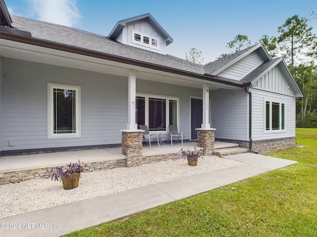 exterior space featuring a front lawn and covered porch