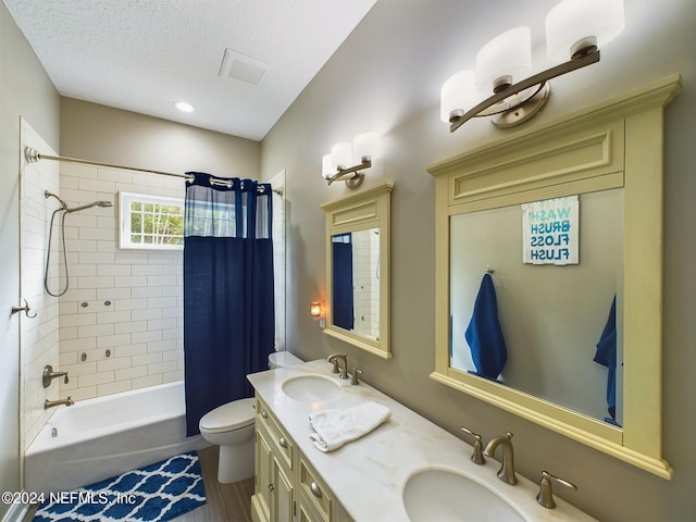 full bathroom with shower / bath combination with curtain, a textured ceiling, toilet, wood-type flooring, and vanity