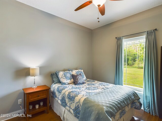 bedroom with hardwood / wood-style floors and ceiling fan