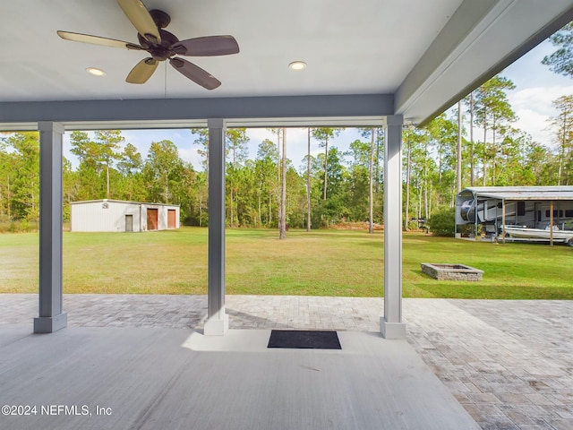 view of patio featuring ceiling fan and an outdoor structure