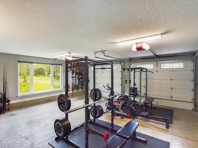 exercise area with concrete flooring and a textured ceiling