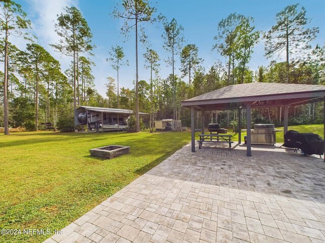 view of home's community featuring a gazebo, a yard, and a fire pit