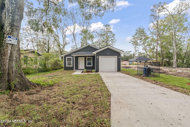 view of front of house with a garage and a front yard