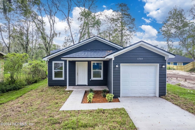 view of front of property with a front lawn and a garage