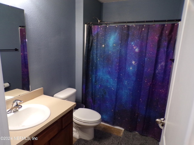 bathroom with tile patterned floors, vanity, and toilet