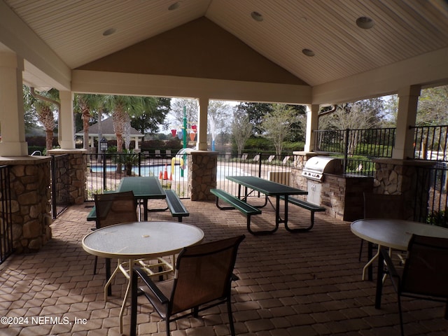 view of patio / terrace with a gazebo, area for grilling, and exterior kitchen