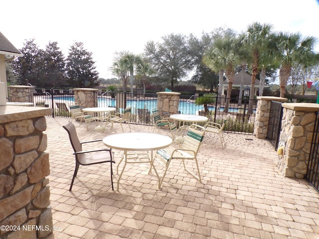 view of patio featuring a community pool