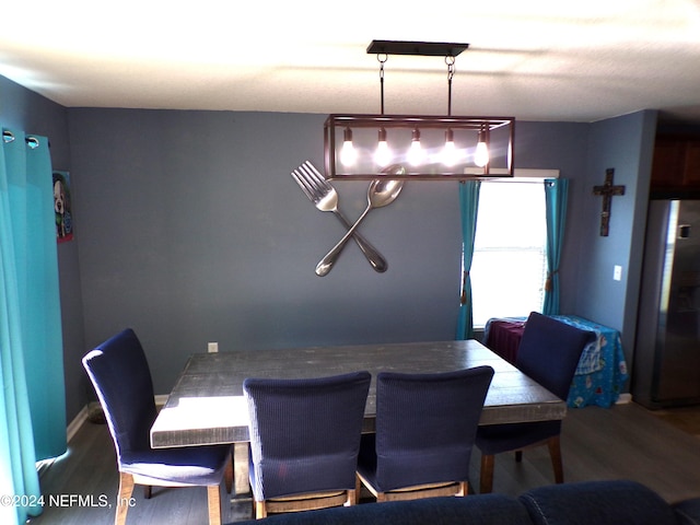 dining space with dark hardwood / wood-style flooring