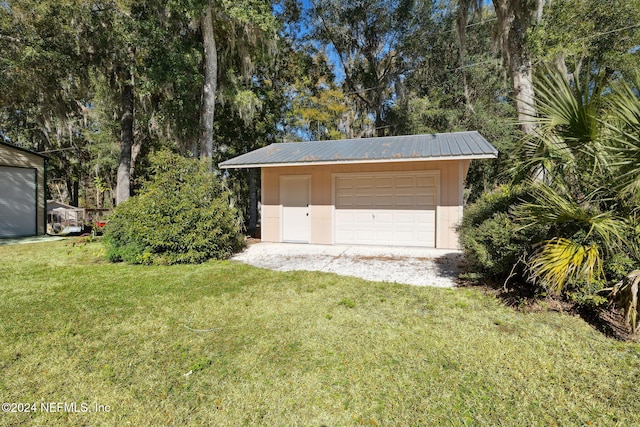 garage featuring a lawn