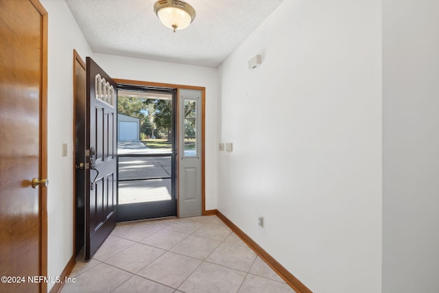 tiled foyer with a textured ceiling