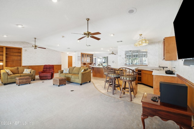 living room with light carpet and vaulted ceiling