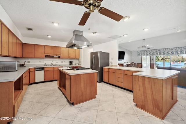 kitchen featuring a center island, stainless steel appliances, a textured ceiling, lofted ceiling, and island range hood