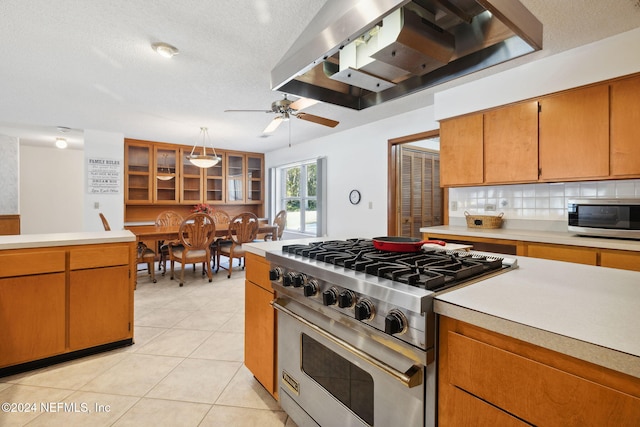 kitchen featuring ventilation hood, stainless steel appliances, ceiling fan, light tile patterned floors, and decorative light fixtures