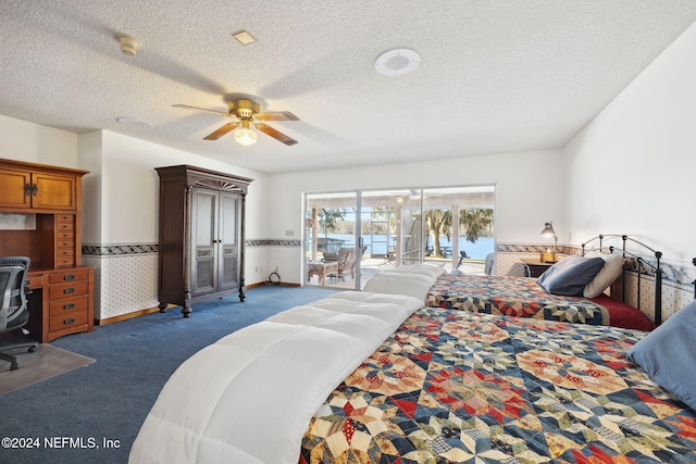 carpeted bedroom with access to outside, ceiling fan, and a textured ceiling