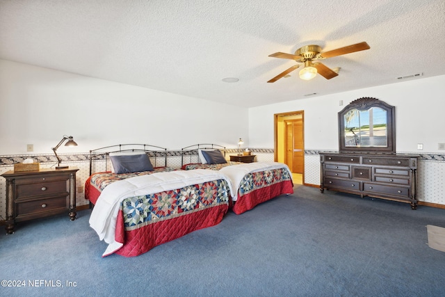 carpeted bedroom featuring a textured ceiling and ceiling fan