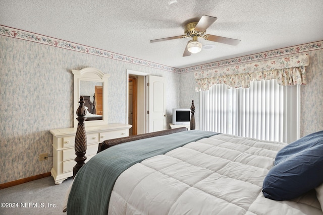 carpeted bedroom featuring a textured ceiling and ceiling fan